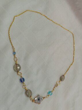 A pretty, minimalist, asymmetrical, reversible handmade necklace